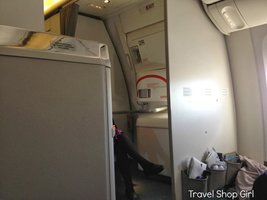 Our seat in row 23 gave us a view of the bulkhead and the seated flight attendant